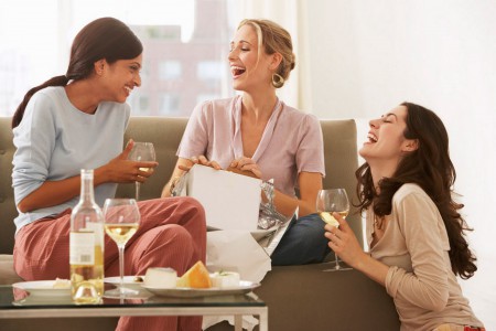 Women drinking wine and laughing-1587590